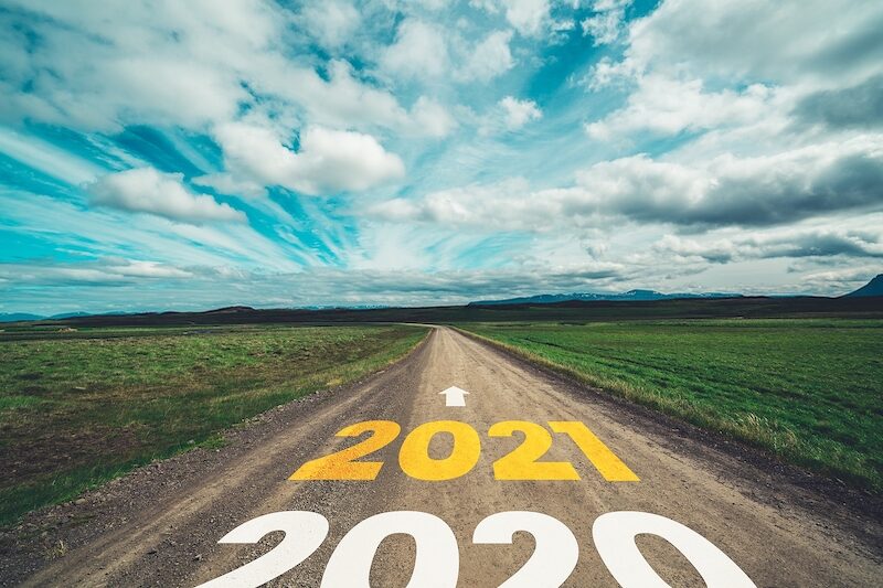 2021 New Year road trip travel and future vision concept . Nature landscape with highway road leading forward to happy new year celebration in the beginning of 2021 for fresh and successful start .