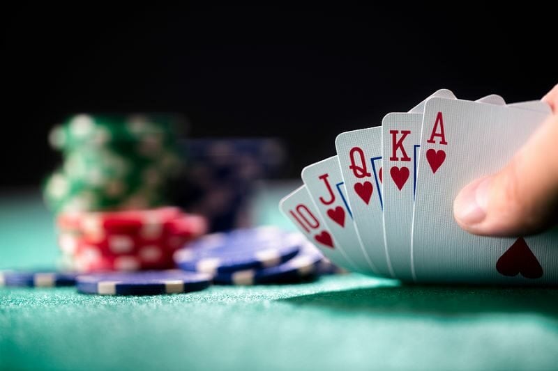 bigstock-Playing-poker-in-a-casino-hold-407131004
