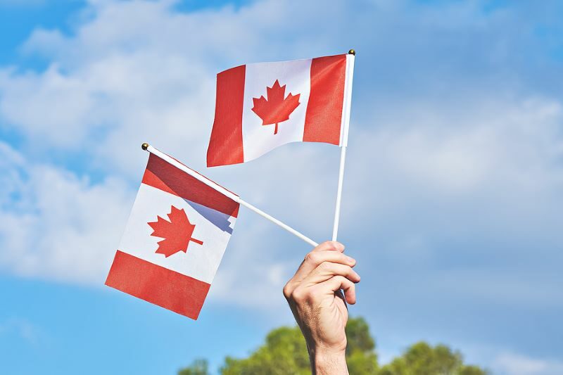 bigstock-Raised-Hand-With-Two-Waving-Ca-373157266