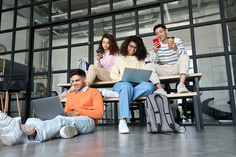 Young Happy Cheerful Multiethnic Cool Group Of High School College Students Girls And Guys Sitting A