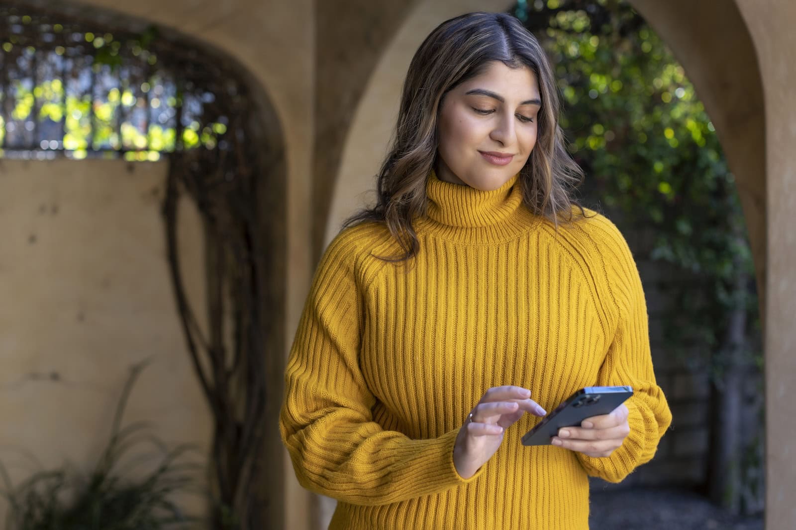 Young woman on iPhone outside